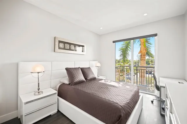 a bedroom with a large bed and a window