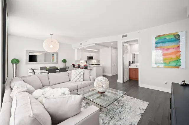 a living room with furniture and kitchen view