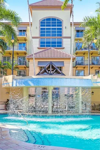 a front view of a building with a garden