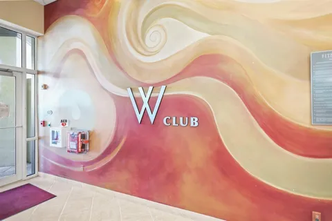 a view of a dining room with furniture one side kitchen view