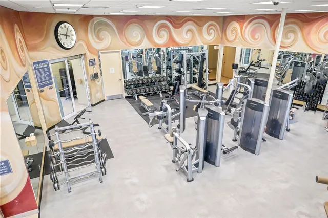 a balcony with wooden floor table and chairs