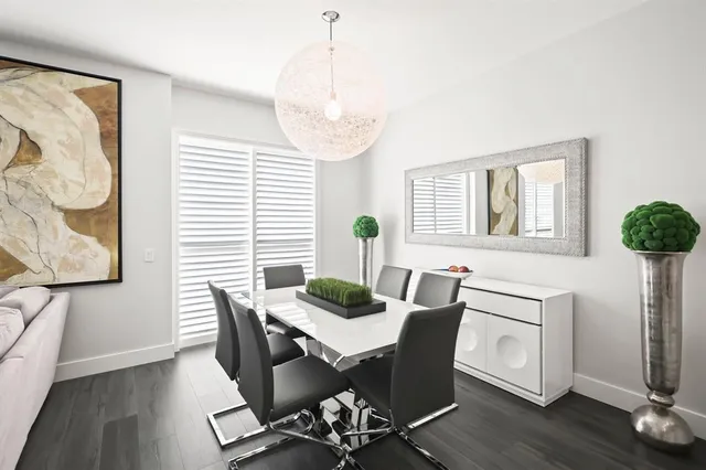 a dining room with furniture and wooden floor