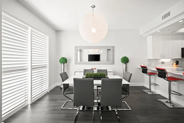 a view of a dining room with furniture and a window