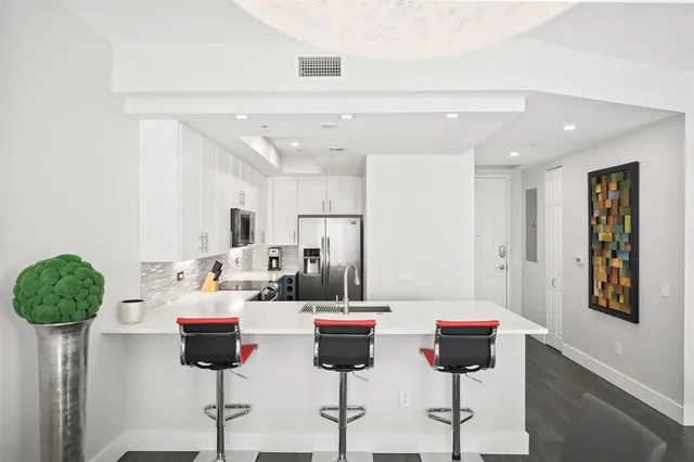 a kitchen with a table and chairs