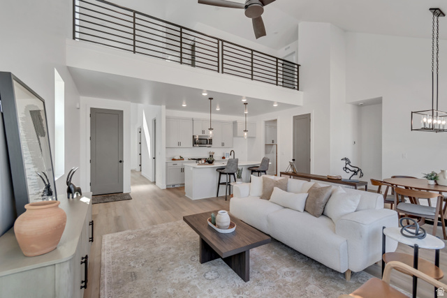 1302 1475 East, Unit 40 Payson, UT 84651 - Photo 15 of 34 Living room with light wood-style floors, ceiling fan, a high ceiling, and recessed lighting