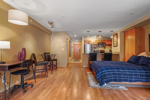 a living room with a bed and a table