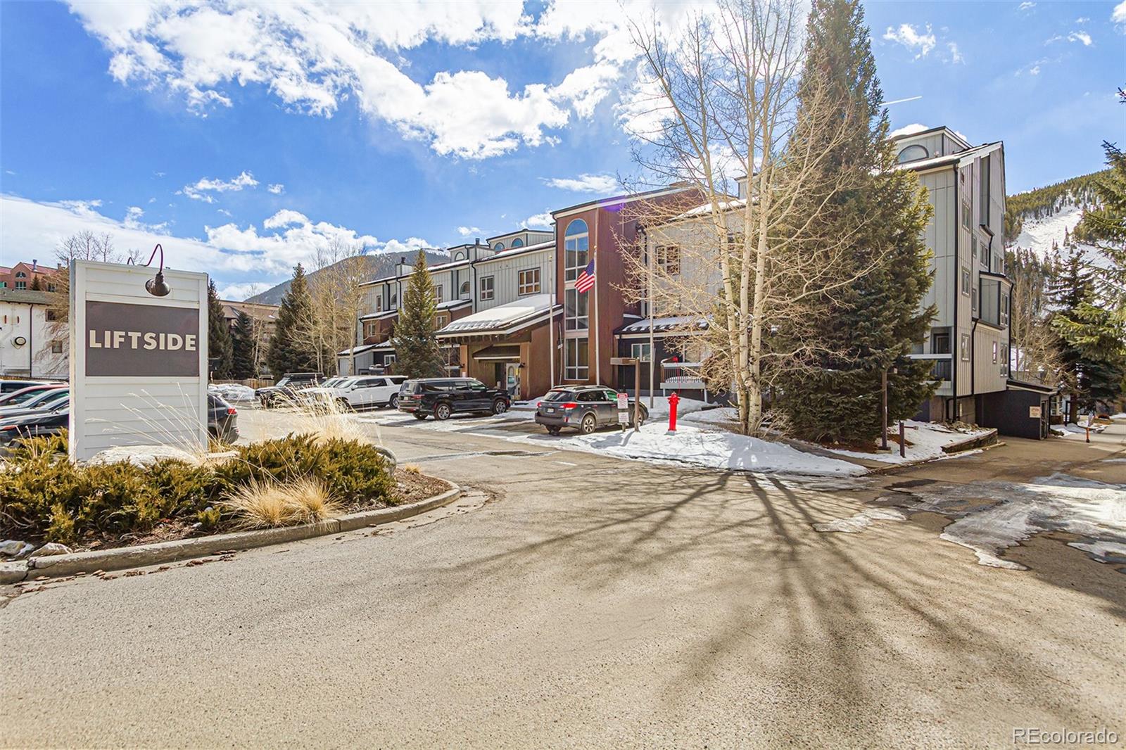 22864 Highway 6, Unit 107 Keystone, CO 80435 - Photo 2 of 20 a street view with tall buildings and cars parked on the roadside