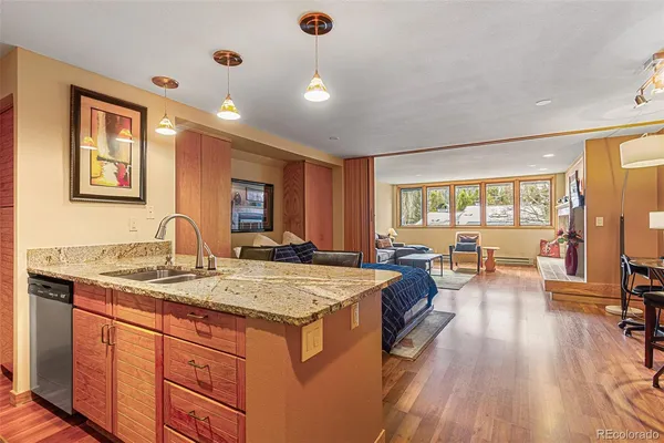 a spacious bathroom with a granite countertop sink a mirror and next to a window