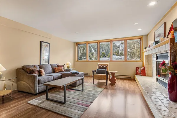 a living room with furniture and a wooden floor