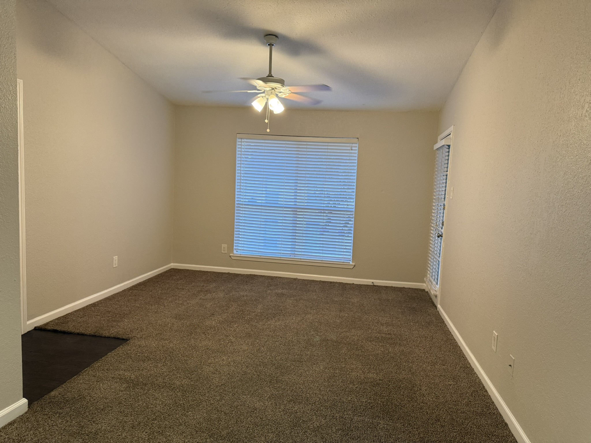 16303 Lyons School Road, Unit 304 Spring, TX 77379 - Photo 9 of 17 en empty room with windows and chandelier
