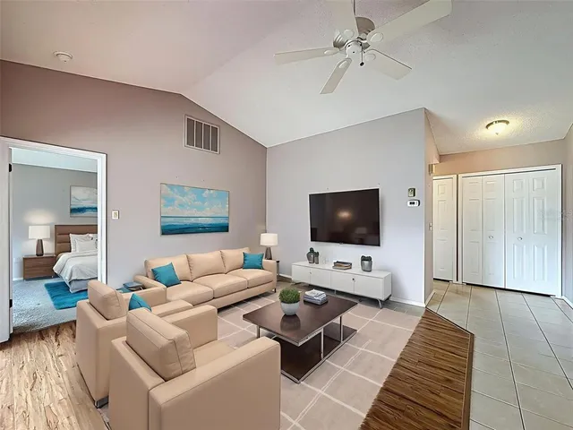 a dining room with furniture a chandelier and wooden floor