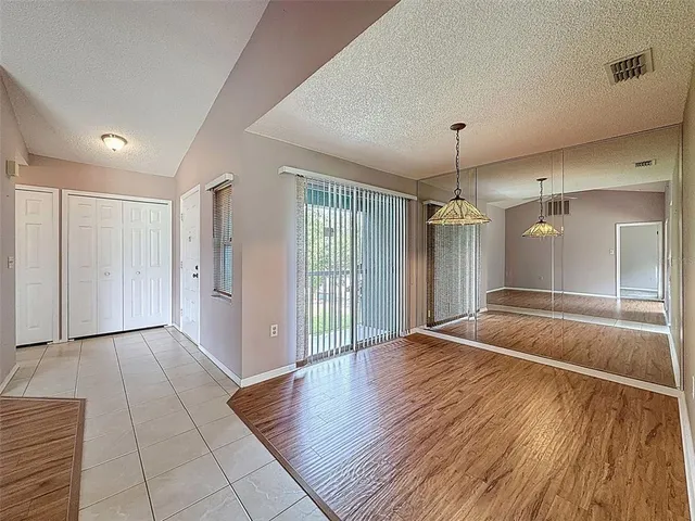 a kitchen with granite countertop wooden cabinets stainless steel appliances and a window