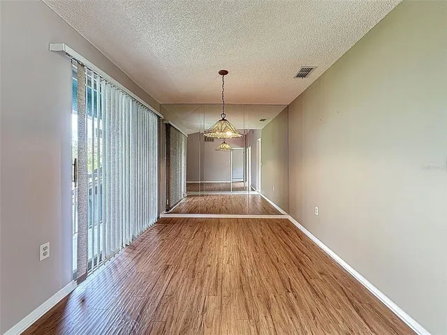 a kitchen with granite countertop a sink a stove and refrigerator