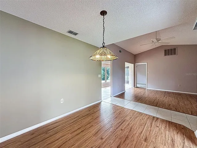 a kitchen with stainless steel appliances granite countertop a sink refrigerator and cabinets