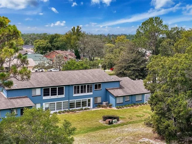 an aerial view of a house with a yard