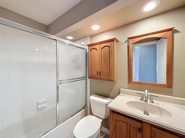 a view of a house with entrance stairs and a garden