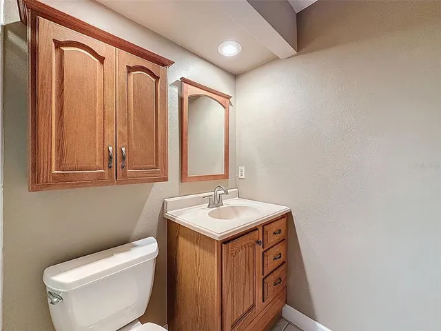 a aerial view of a house with a yard balcony and tree