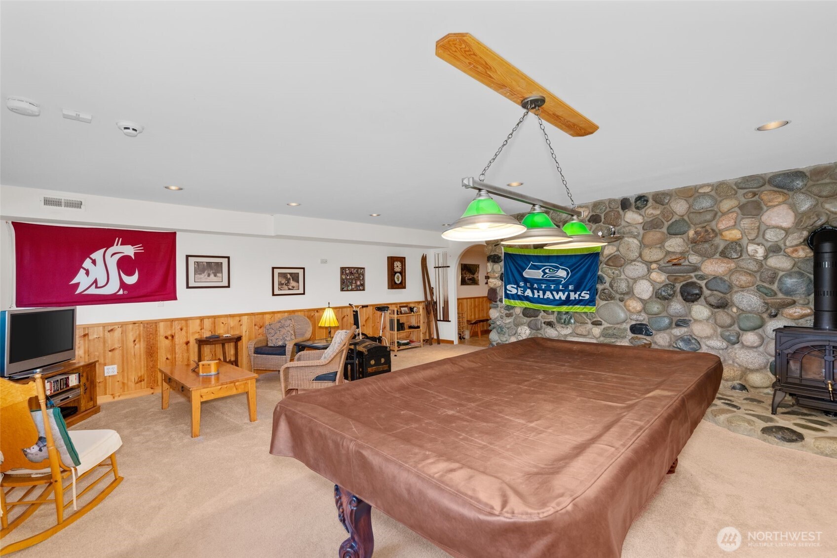 11411 Shugart Flats Road Leavenworth, WA 98826 - Photo 34 of 40 a living room with furniture a flat screen tv and a table