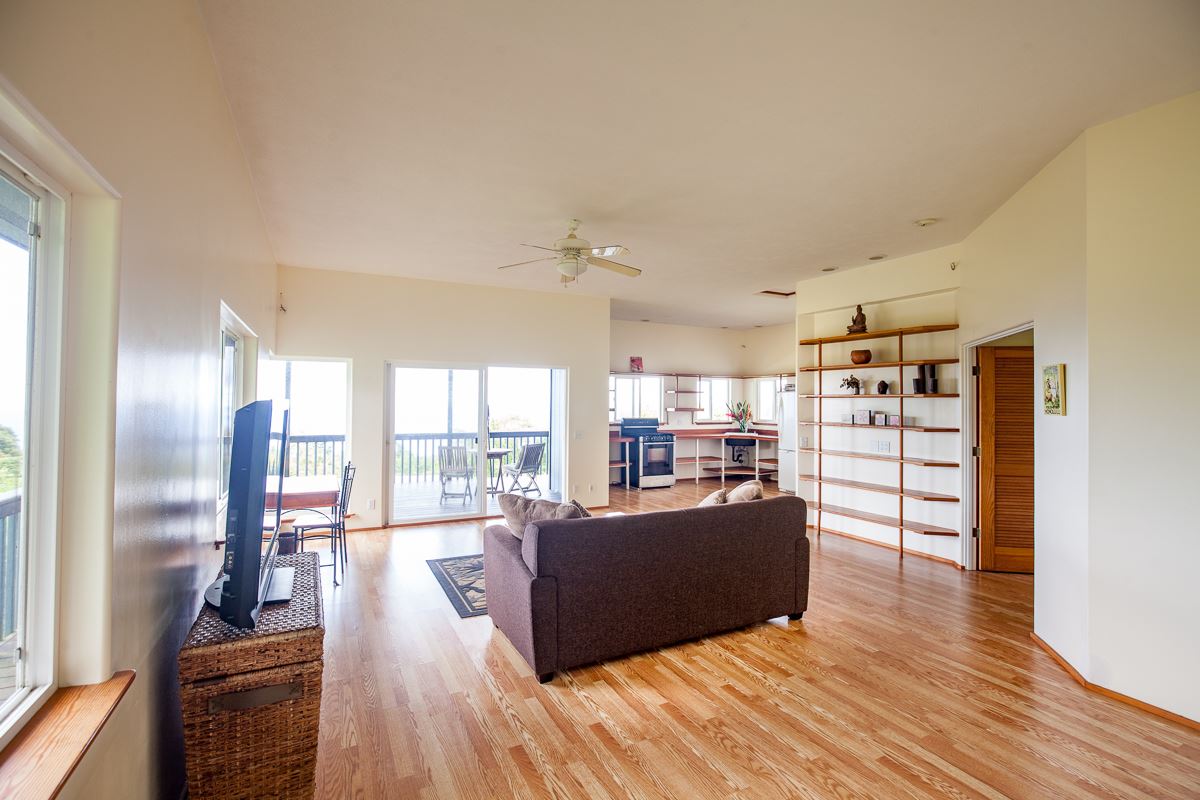 750 Kapia Road, Unit 36 Hana, HI 96713 - Photo 17 of 29 a living room with furniture a large window and wooden floor