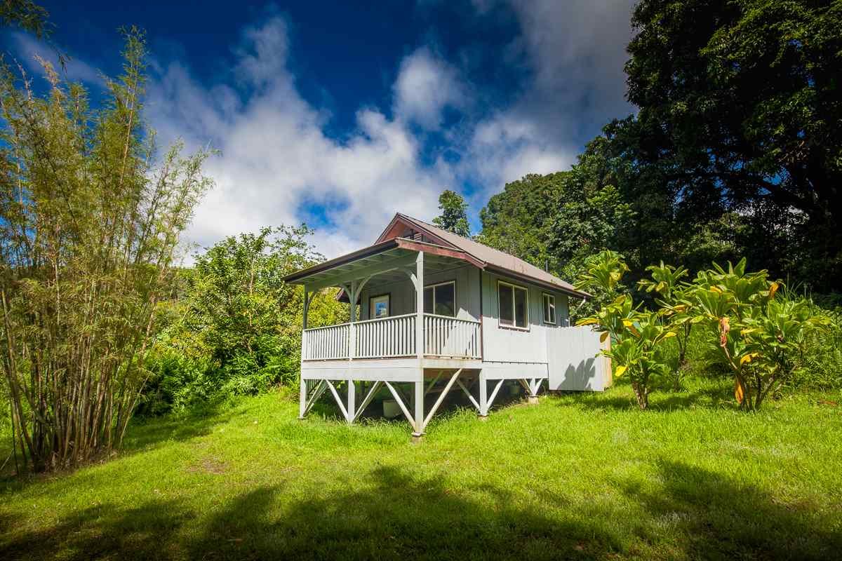 750 Kapia Road, Unit 36 Hana, HI 96713 - Photo 24 of 29 a white house with a big yard plants and large trees