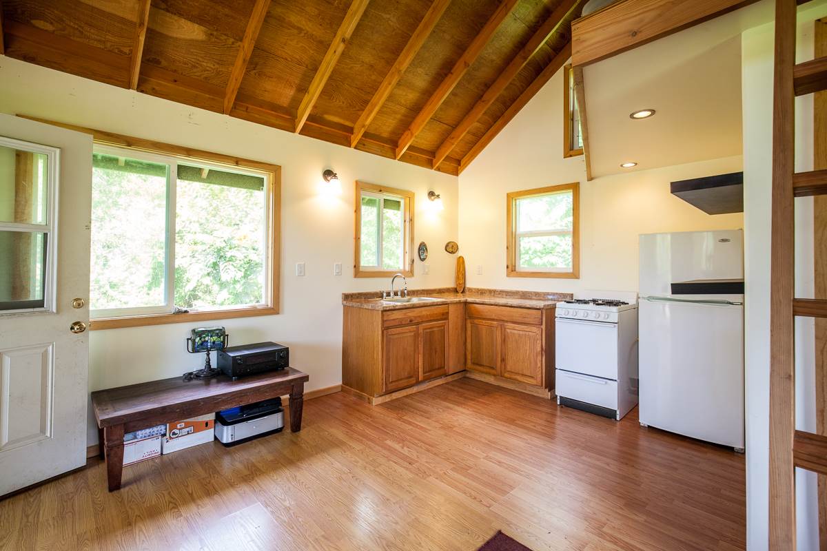 750 Kapia Road, Unit 36 Hana, HI 96713 - Photo 27 of 29 a kitchen with sink cabinets and wooden floor
