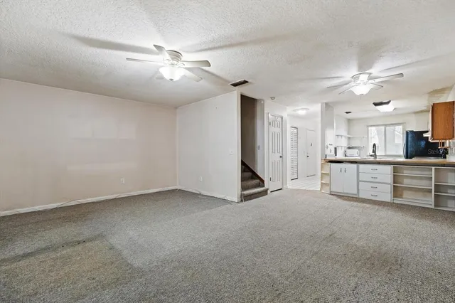 a view of an empty room with a ceiling fan