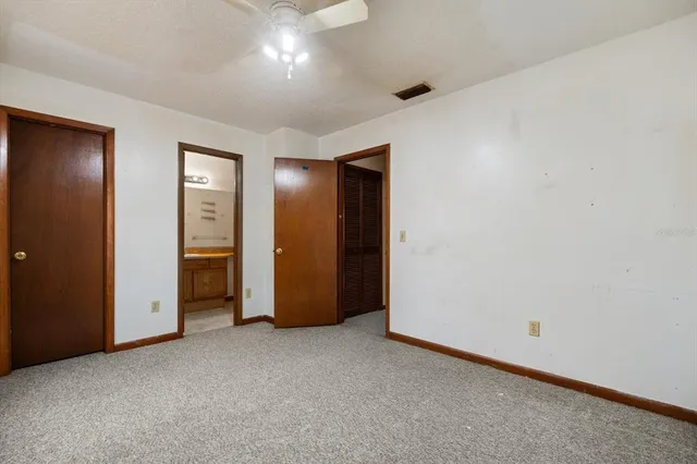 an empty room with closet and a bathroom