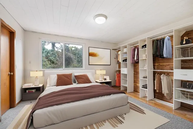 a bedroom with a large bed and a window