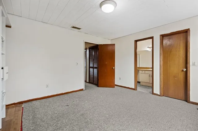 an empty room with closet and a fireplace