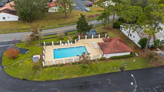 an aerial view of a house with garden space and street view