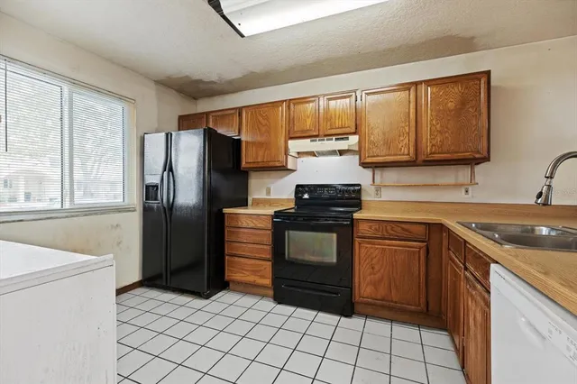 a kitchen with a stove sink and refrigerator