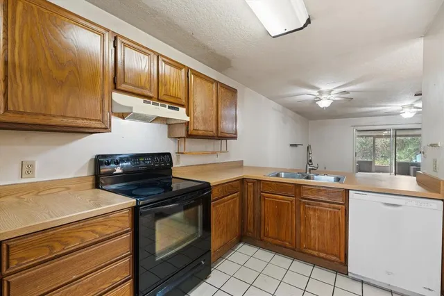 a kitchen with a sink stove and cabinets
