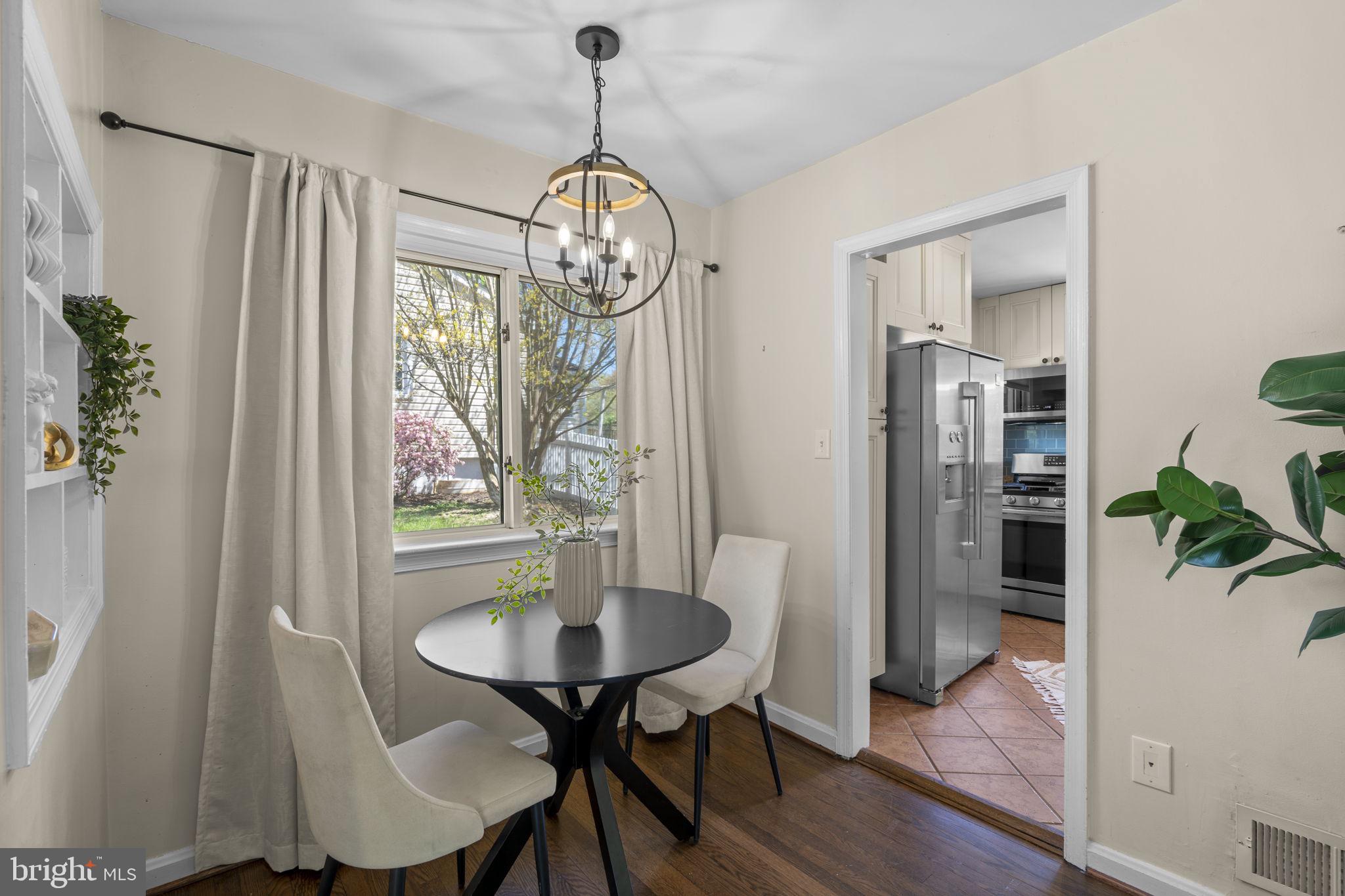 7005 Grove Road Alexandria, VA 22306 - Photo 12 of 52 a view of a dining room with furniture window and wooden floor