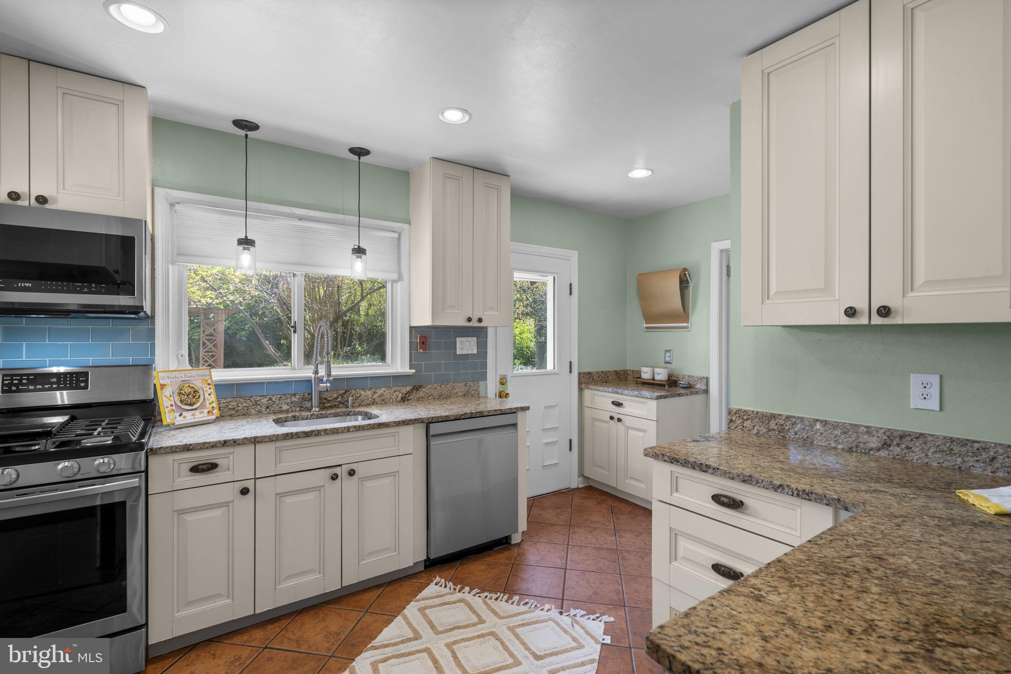7005 Grove Road Alexandria, VA 22306 - Photo 15 of 52 a kitchen with white cabinets and appliances