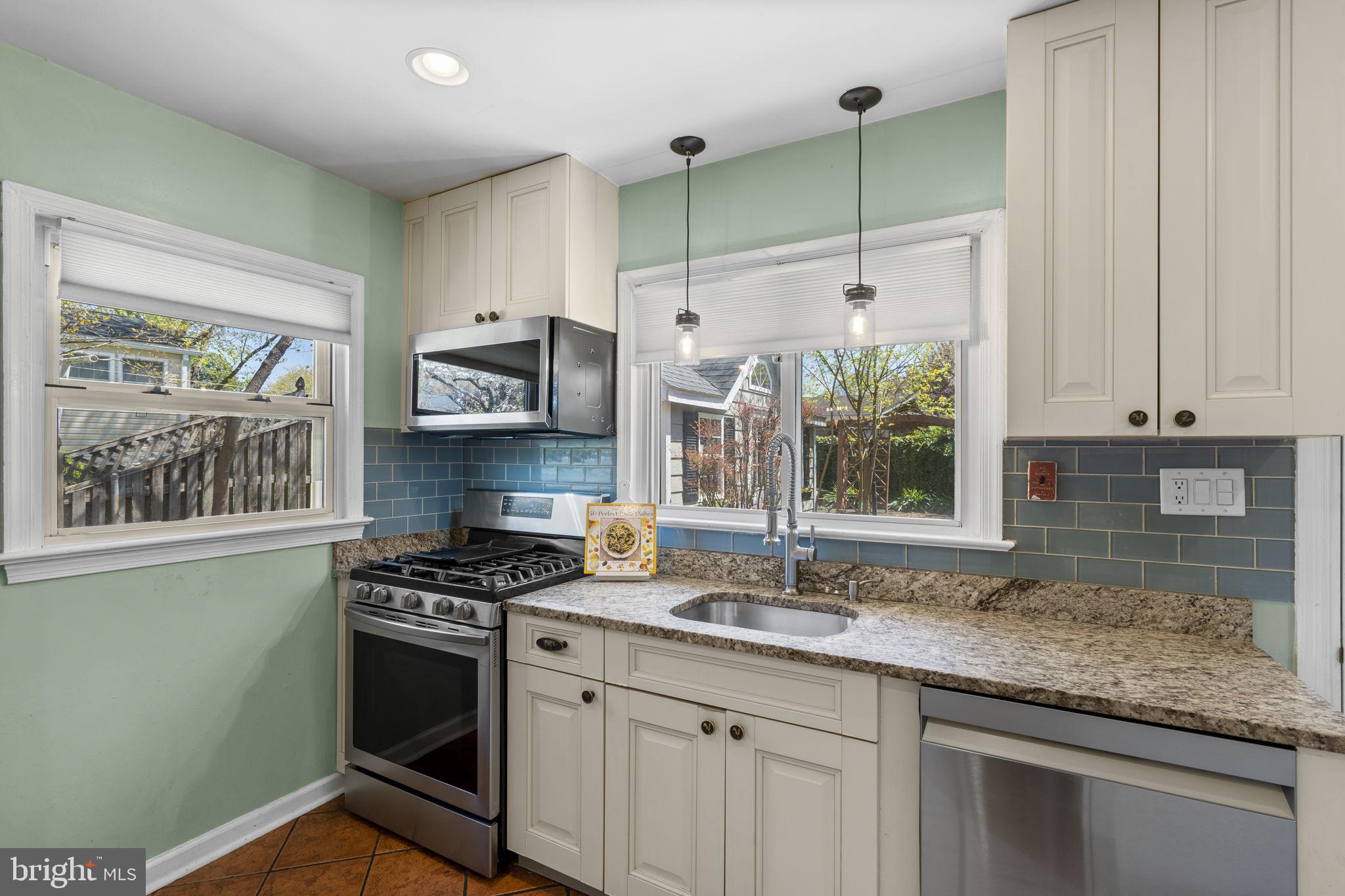 7005 Grove Road Alexandria, VA 22306 - Photo 17 of 52 a kitchen with stainless steel appliances granite countertop a sink stove and cabinets