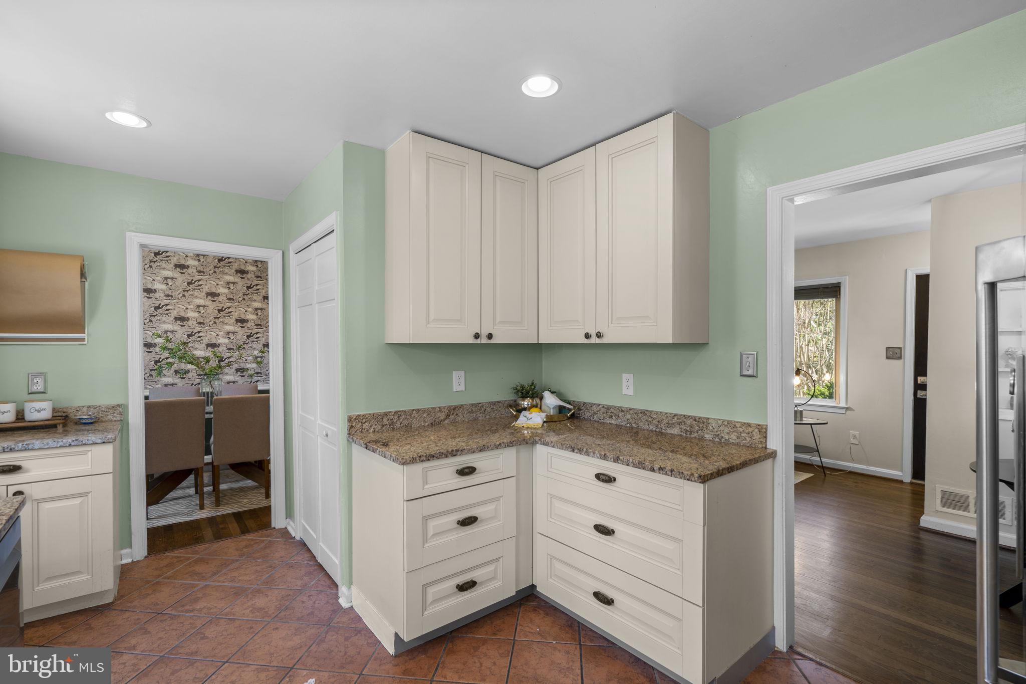 7005 Grove Road Alexandria, VA 22306 - Photo 19 of 52 a kitchen with granite countertop a sink cabinets and wooden floor