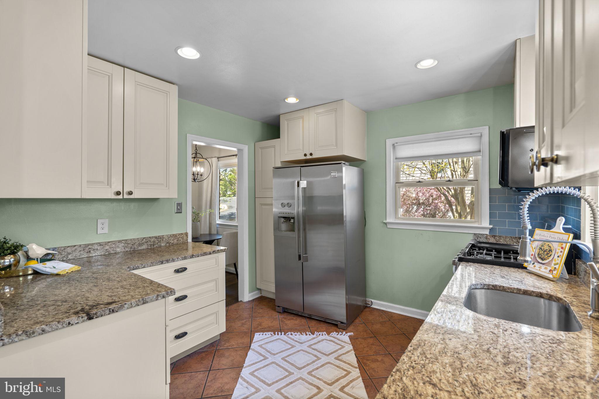 7005 Grove Road Alexandria, VA 22306 - Photo 20 of 52 a kitchen with granite countertop a sink stove and refrigerator