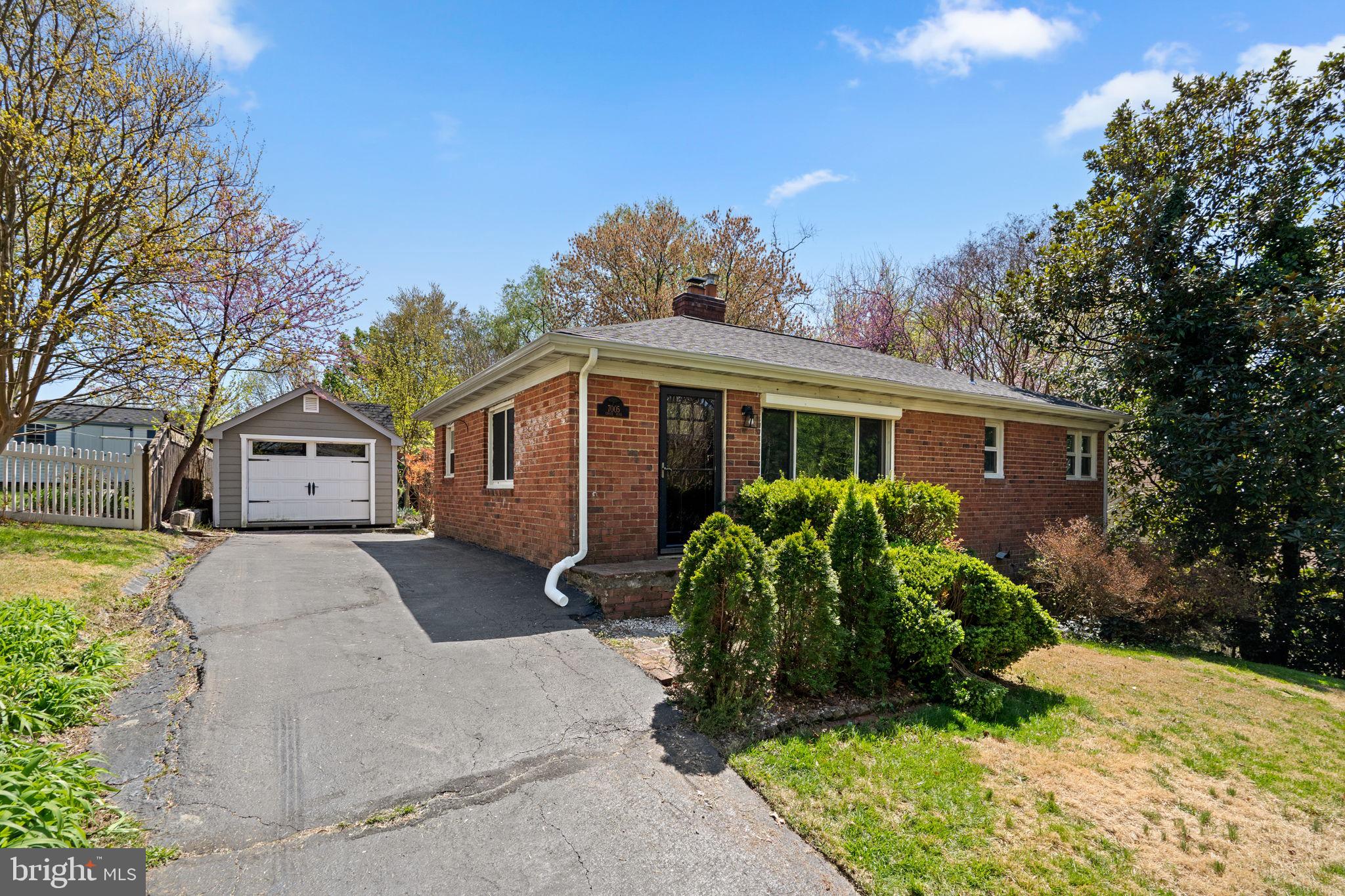 7005 Grove Road Alexandria, VA 22306 - Photo 2 of 52 a front view of house with yard and trees around