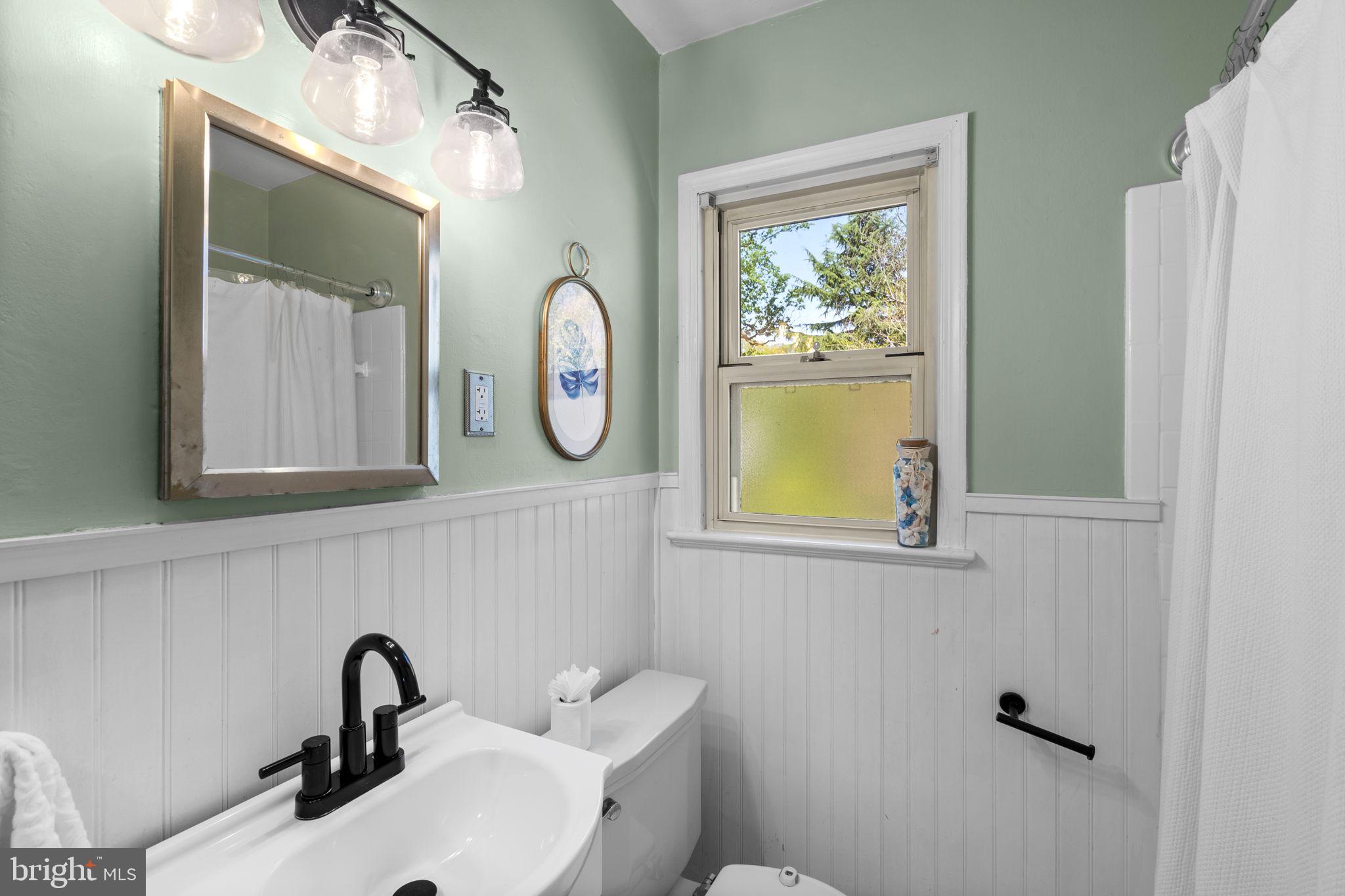 7005 Grove Road Alexandria, VA 22306 - Photo 33 of 52 a bathroom with a sink and a mirror