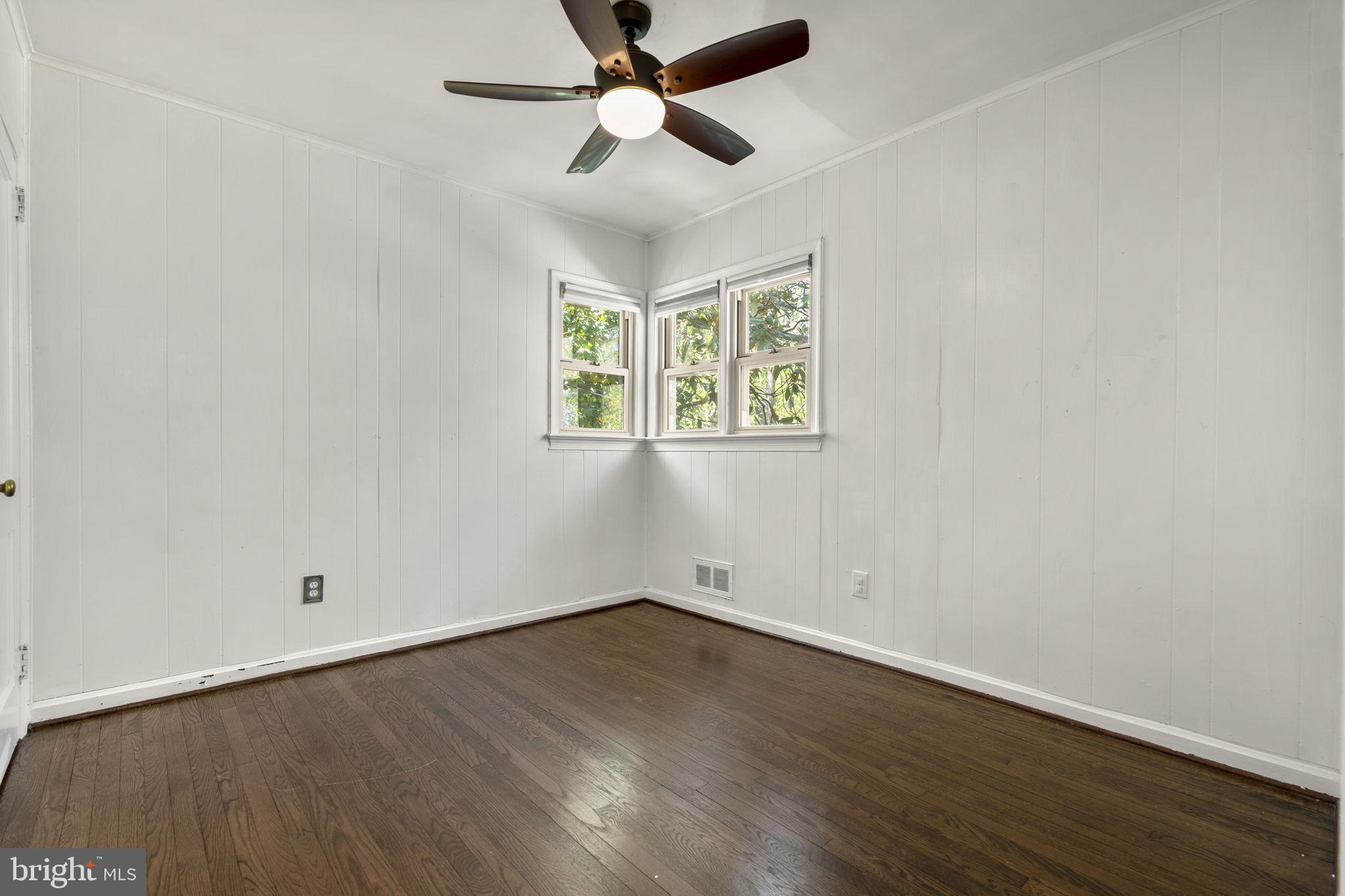 7005 Grove Road Alexandria, VA 22306 - Photo 34 of 52 an empty room with wooden floor and windows