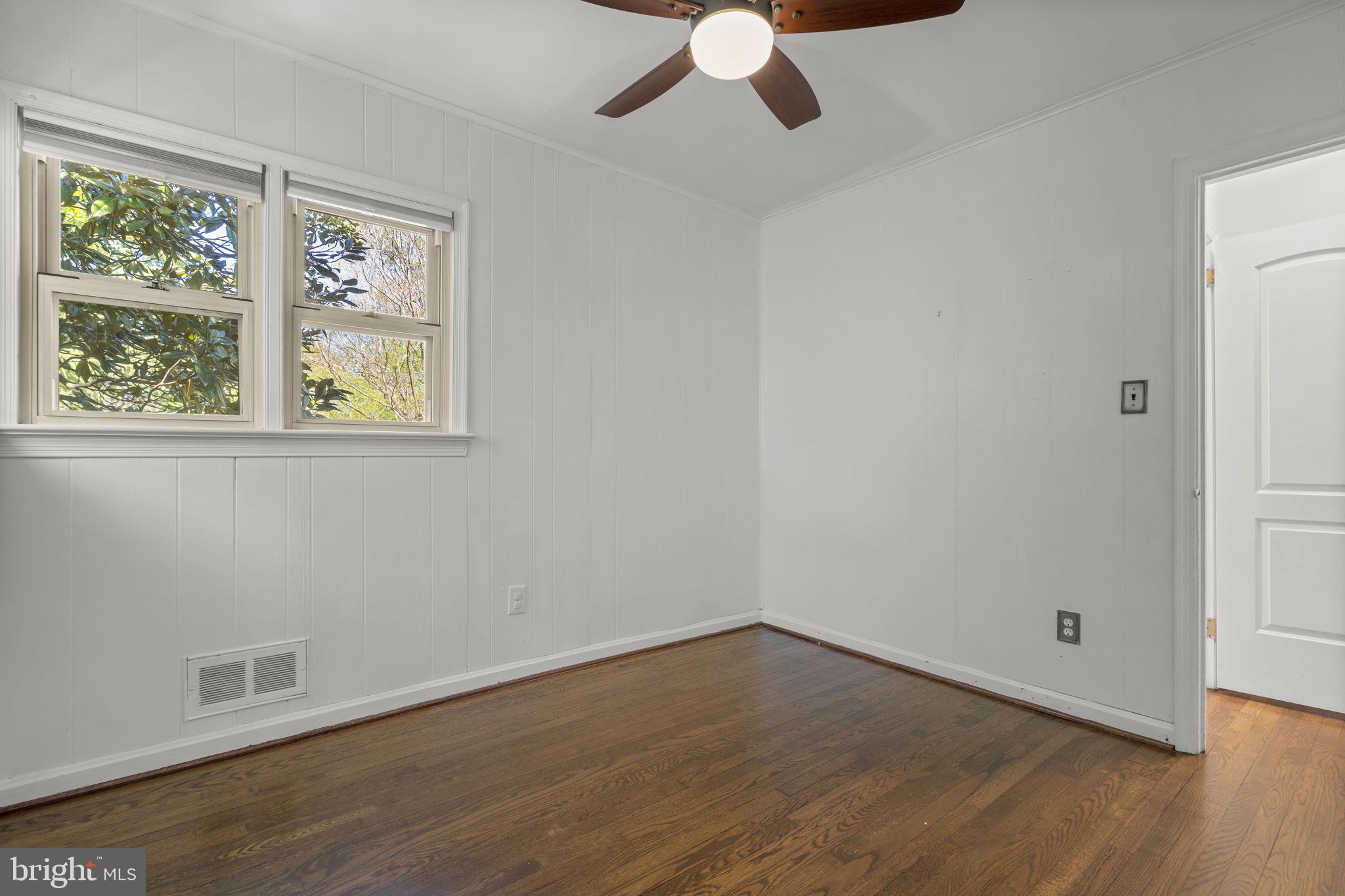 7005 Grove Road Alexandria, VA 22306 - Photo 35 of 52 wooden floor in an empty room with a window