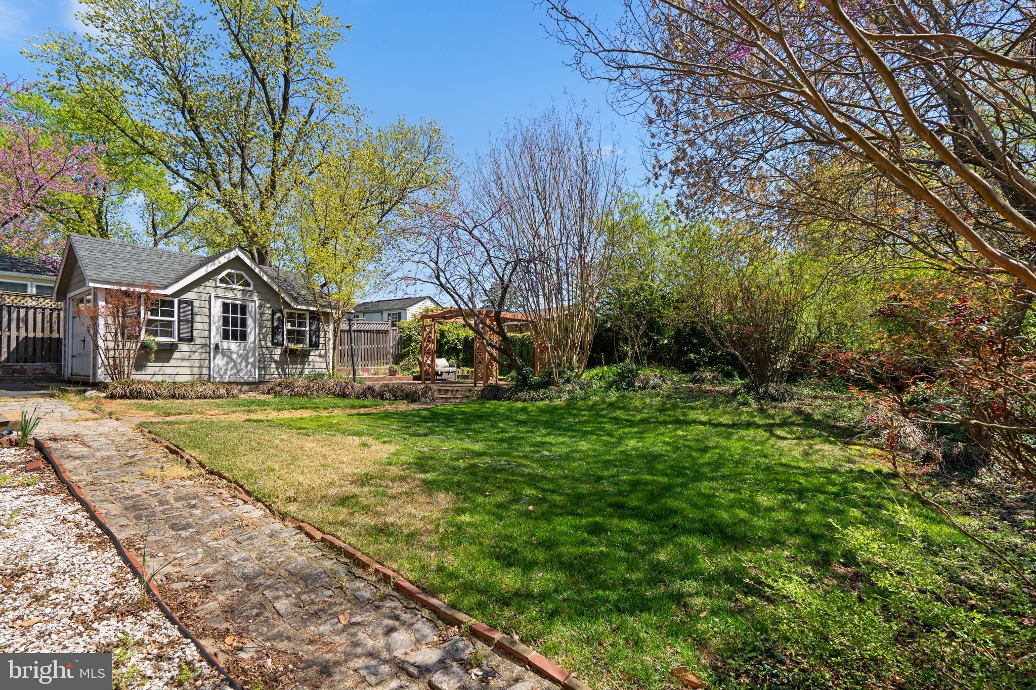 7005 Grove Road Alexandria, VA 22306 - Photo 41 of 52 a view of house with garden and trees