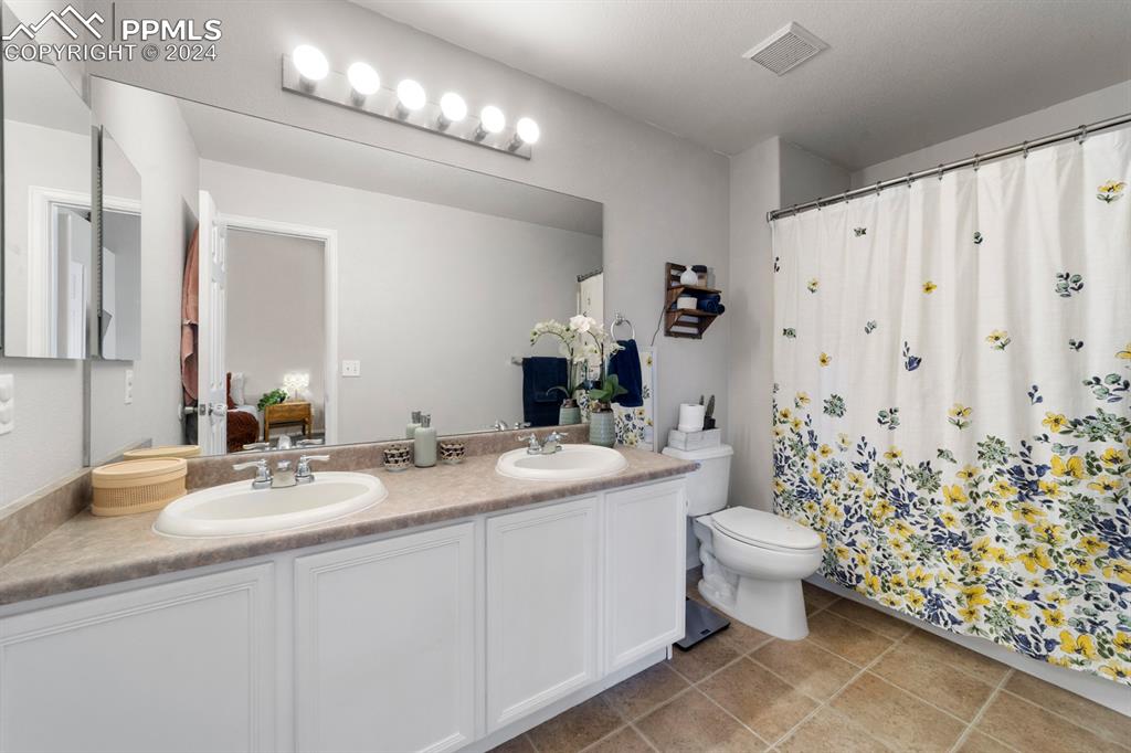 7375 Sandy Springs Point Fountain, CO 80817 - Photo 11 of 31 a bathroom with a toilet sink and mirror