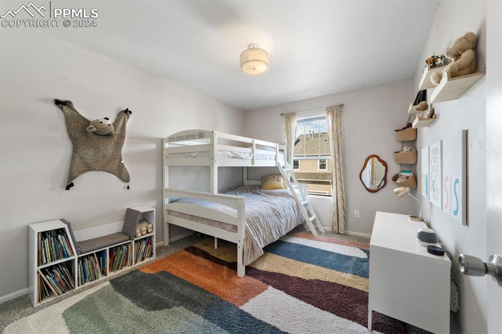 7375 Sandy Springs Point Fountain, CO 80817 - Photo 13 of 31 a bedroom with furniture and a large window