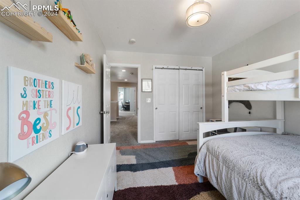 7375 Sandy Springs Point Fountain, CO 80817 - Photo 16 of 31 a bedroom with a bed and a painting on the wall