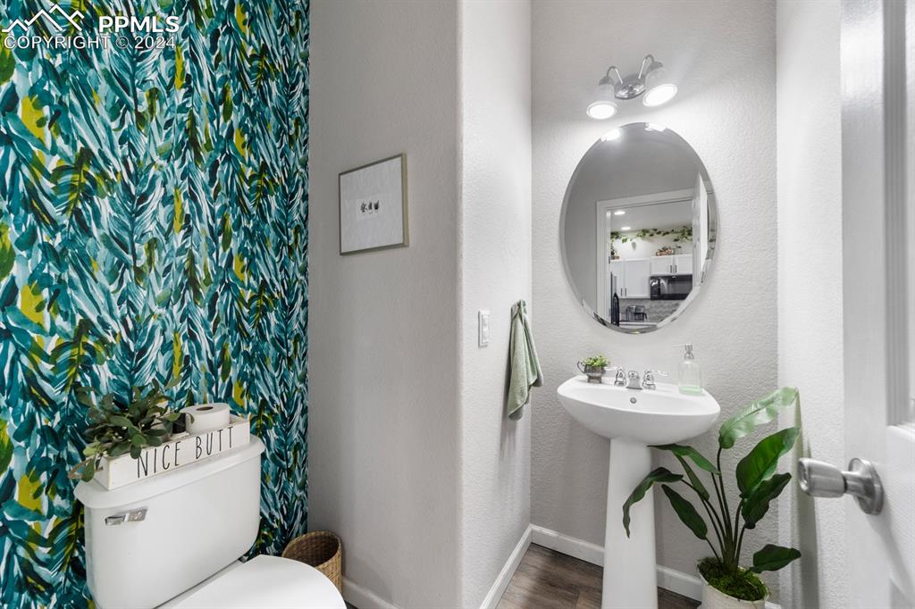 7375 Sandy Springs Point Fountain, CO 80817 - Photo 20 of 31 a bathroom with a toilet sink and mirror