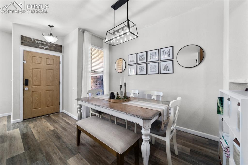 7375 Sandy Springs Point Fountain, CO 80817 - Photo 21 of 31 a view of a dining room with furniture window and wooden floor