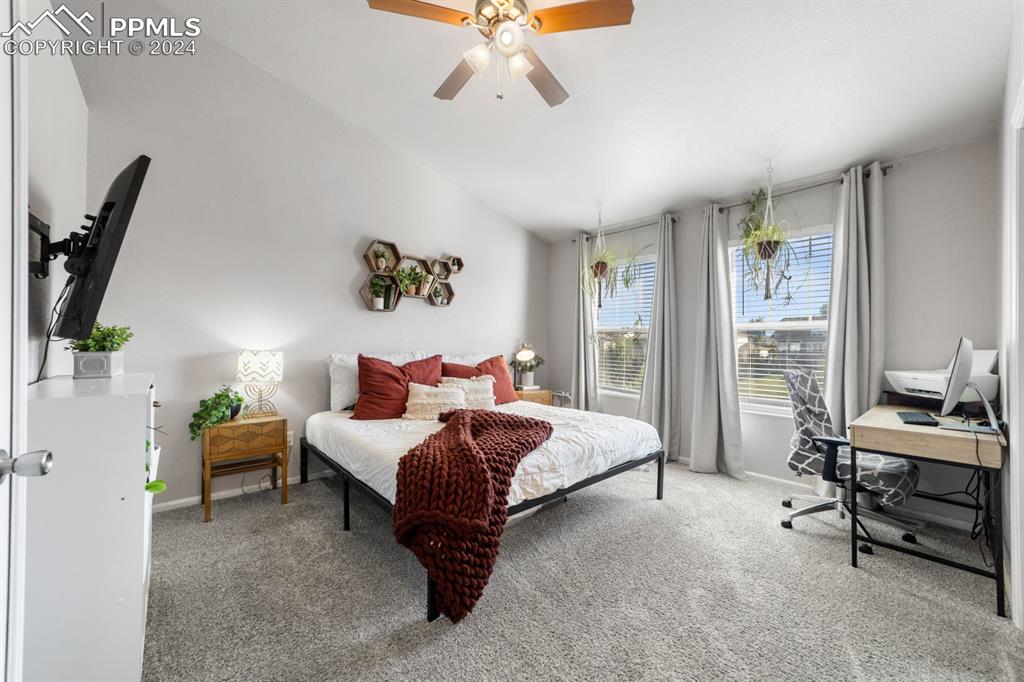 7375 Sandy Springs Point Fountain, CO 80817 - Photo 8 of 31 a spacious bedroom with a bed and a chandelier