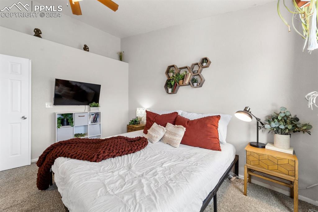 7375 Sandy Springs Point Fountain, CO 80817 - Photo 9 of 31 a bedroom with a bed and a flat screen tv