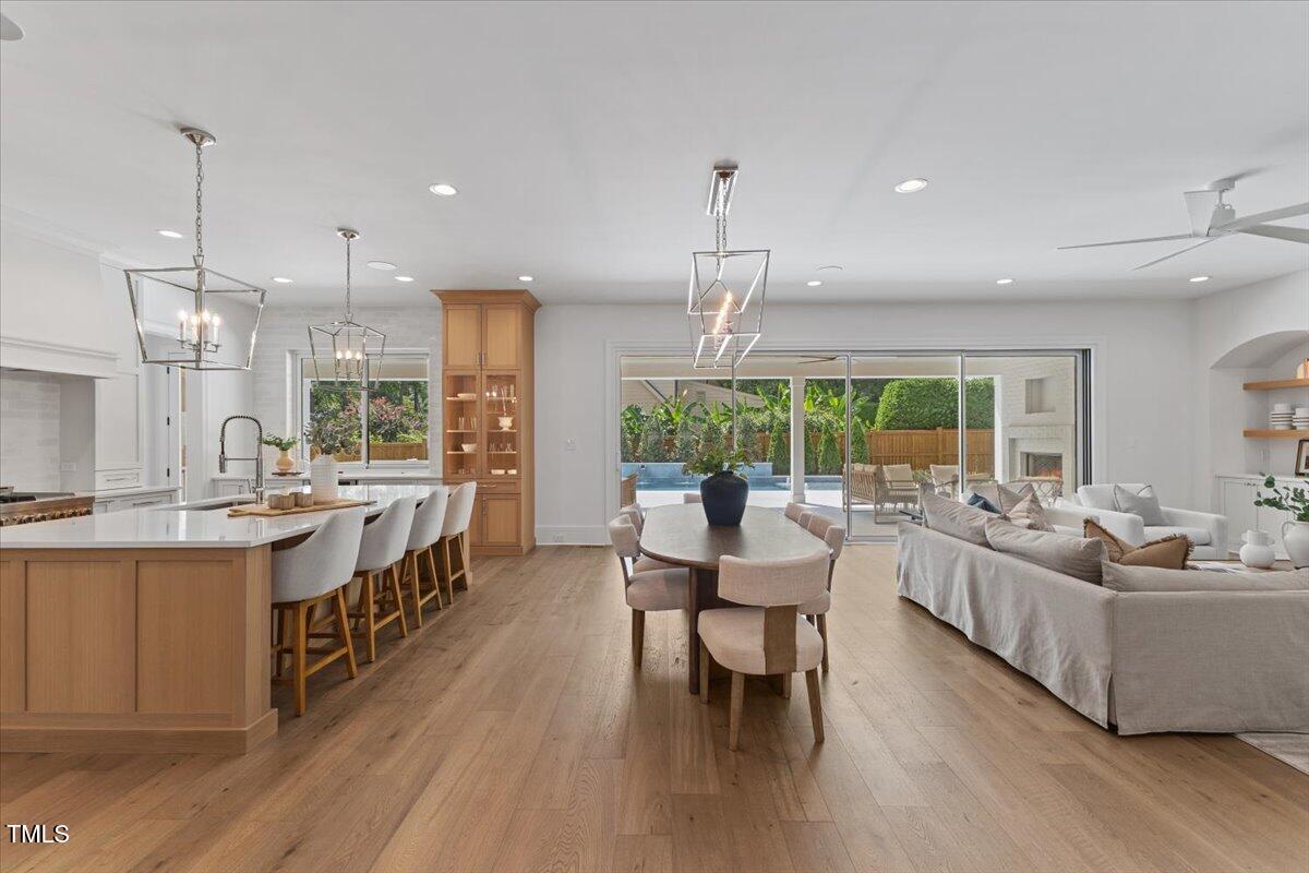 6844 Greystone Drive Raleigh, NC 27615 - Photo 14 of 83 a large white kitchen with lots of counter space dining table and chairs